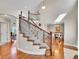 Elegant curved staircase with decorative iron railings and hardwood floors at 9845 Glenstone Trl, Highlands Ranch, CO 80130