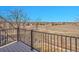 Balcony view overlooking a green field and residential community in the distance at 9845 Glenstone Trl, Highlands Ranch, CO 80130