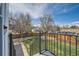 View of the fenced backyard and garden from the deck with railings at 16503 E Yale Pl, Aurora, CO 80013