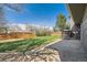 View of a well-maintained backyard with grass, concrete patio and a wood fence at 16503 E Yale Pl, Aurora, CO 80013