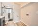 Bathroom & laundry area showcasing modern fixtures, subway tile shower and wood-look flooring at 16503 E Yale Pl, Aurora, CO 80013
