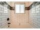 View of white tiled shower and tub with accent tile work at 16503 E Yale Pl, Aurora, CO 80013