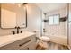 Bathroom featuring new white vanity, toilet, gray walls and white tiled shower and tub at 16503 E Yale Pl, Aurora, CO 80013