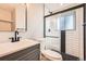 Nicely updated bathroom featuring a modern vanity, toilet, and tiled shower with glass doors at 16503 E Yale Pl, Aurora, CO 80013