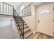 View of entryway featuring staircase with metal railing and laminate wood flooring at 16503 E Yale Pl, Aurora, CO 80013