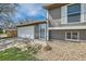 Close up view of two-story home with garage, front entrance and neutral colored siding at 16503 E Yale Pl, Aurora, CO 80013