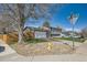 View of a brown home with white trim, basketball hoop and yellow fire hydrant on corner lot at 16503 E Yale Pl, Aurora, CO 80013