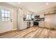 Updated kitchen with modern cabinets, stainless steel appliances, and new laminate floors at 16503 E Yale Pl, Aurora, CO 80013