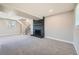 Spacious living room featuring gray carpet, brick fireplace, stairs and a window at 16503 E Yale Pl, Aurora, CO 80013