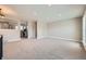 Spacious living room boasts modern lighting, neutral paint, and a view into the updated kitchen at 16503 E Yale Pl, Aurora, CO 80013