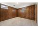 Basement corner showing wood paneling, carpet, and window, ideal as a den or home office, providing privacy and comfort at 509 Newland St, Lakewood, CO 80226