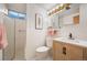 Neat bathroom with a walk-in shower, white subway tile, modern vanity and toilet, offering a clean, updated space at 509 Newland St, Lakewood, CO 80226