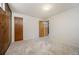 Cozy bedroom with wood paneling, carpet, an open closet and entry offering a warm and inviting atmosphere at 509 Newland St, Lakewood, CO 80226
