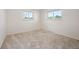Spacious carpeted bedroom with ample natural light and neutral paint at 509 Newland St, Lakewood, CO 80226