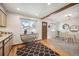 An open view of the dining area featuring a modern table, chairs, and natural lighting at 509 Newland St, Lakewood, CO 80226