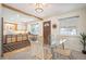 Open view of the dining area with a glass table and direct access to the kitchen at 509 Newland St, Lakewood, CO 80226