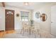 Bright dining area featuring a glass table, wicker chairs, and a view of the backyard at 509 Newland St, Lakewood, CO 80226