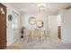 Cozy dining area with a glass table, woven chairs, and natural light from the window at 509 Newland St, Lakewood, CO 80226