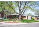 Brick home with solar panels, a green lawn, and mature trees, set on a corner lot in a neighborhood at 509 Newland St, Lakewood, CO 80226