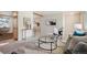 Open living room featuring stylish decor, modern furniture, and hardwood floors transitioning to carpet at 509 Newland St, Lakewood, CO 80226