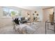 Bright living room featuring stylish decor, a comfortable sofa, and large window at 509 Newland St, Lakewood, CO 80226
