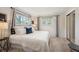 Comfortable main bedroom with two large windows and ample natural light and soft textures at 509 Newland St, Lakewood, CO 80226