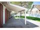Covered outdoor patio with a concrete floor, offering a comfortable extension of the home's living space at 509 Newland St, Lakewood, CO 80226