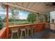 Outdoor back porch with wood flooring, orange railings, a view of the backyard and bar stool seating at 16667 Tin Cup Ct, Parker, CO 80134