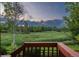 Beautiful backyard view from the back porch showcasing a lush green landscape and mature trees in the evening at 16667 Tin Cup Ct, Parker, CO 80134