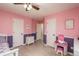 This is a bedroom with pink walls, white trim and doors, and light hardwood floors at 16667 Tin Cup Ct, Parker, CO 80134