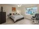 A cozy bedroom with a gray rocking chair, a comfortable bed, and lots of natural light at 16667 Tin Cup Ct, Parker, CO 80134