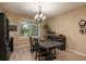 Dining room featuring a dark wood table, chandelier lighting and a window at 16667 Tin Cup Ct, Parker, CO 80134