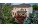 Aerial rear elevation view featuring a spacious deck, a well-maintained lawn, and mature trees at 16667 Tin Cup Ct, Parker, CO 80134