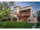 Rear exterior view of the house featuring a deck, stairs, and a well-maintained lawn at 16667 Tin Cup Ct, Parker, CO 80134