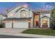 Charming two-story home with a well-manicured lawn, three car garage and attractive brick accents at 16667 Tin Cup Ct, Parker, CO 80134