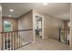 Upstairs hallway featuring railing and entrance to a bedroom at 16667 Tin Cup Ct, Parker, CO 80134