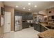 Spacious kitchen with stainless steel appliances, grey cabinets, granite countertops, tile flooring, and ample counter space at 16667 Tin Cup Ct, Parker, CO 80134