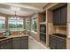 Bright kitchen features granite countertops, stainless steel appliances, gas range cooktop, and a breakfast nook with views at 16667 Tin Cup Ct, Parker, CO 80134
