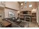 Spacious living room with a fireplace, large sectional sofa, high ceilings, and bright natural light at 16667 Tin Cup Ct, Parker, CO 80134