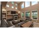 Inviting living room with a cozy fireplace, large windows, and comfortable seating at 16667 Tin Cup Ct, Parker, CO 80134