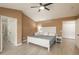 Spacious main bedroom with a ceiling fan, connecting doors, and natural light at 16667 Tin Cup Ct, Parker, CO 80134
