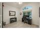 Bright office with a large arched window, ceiling fan, and modern desk setup at 16667 Tin Cup Ct, Parker, CO 80134