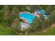 Aerial view of a community pool area surrounded by lush greenery and lounge chairs at 16667 Tin Cup Ct, Parker, CO 80134
