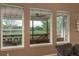 View from the interior of the home that overlooks a peaceful backyard with mature trees and a wooden fence at 16667 Tin Cup Ct, Parker, CO 80134
