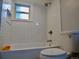 Bright bathroom features white subway tile, a bathtub, and modern fixtures with a view at 2737 N Marion St, Denver, CO 80205