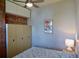 Well-lit bedroom features a full-size bed, closet, exposed brick wall, and stylish decor at 2737 N Marion St, Denver, CO 80205