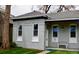 Charming gray brick home with well-maintained lawn and inviting front porch seating at 2737 N Marion St, Denver, CO 80205