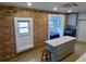 Renovated kitchen with exposed brick and an adjacent breakfast nook at 2737 N Marion St, Denver, CO 80205