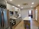 Modern kitchen with gray cabinets, stainless steel appliances and exposed brick wall at 2737 N Marion St, Denver, CO 80205