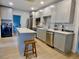 Updated kitchen featuring gray cabinets, stainless appliances, and quartz countertops at 2737 N Marion St, Denver, CO 80205